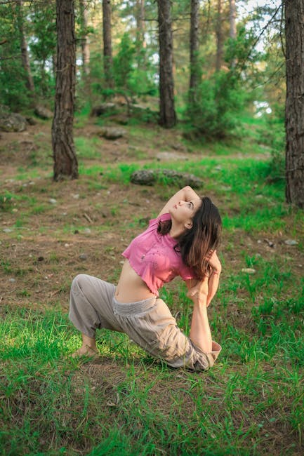 Woman performing a serene yoga pose outdoors in a green natural setting